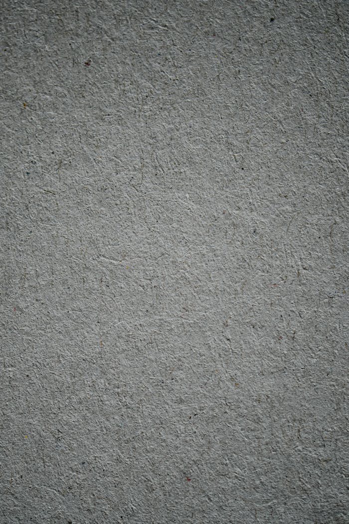A vertical shot of a textured gray concrete surface, ideal for background use.